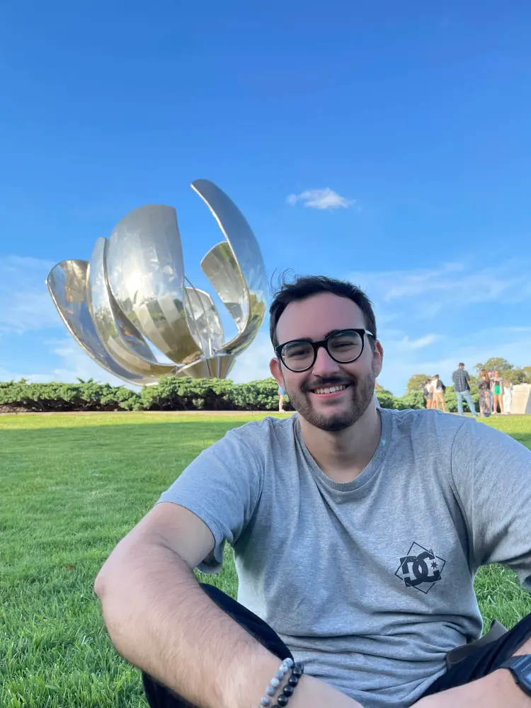 Portrait of Evaldo in front of a sculpture in Buenos Aires.
